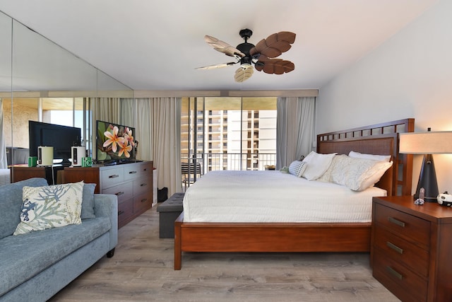 bedroom with access to exterior, light hardwood / wood-style flooring, multiple windows, and ceiling fan