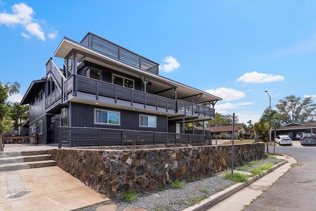 view of side of home featuring a balcony