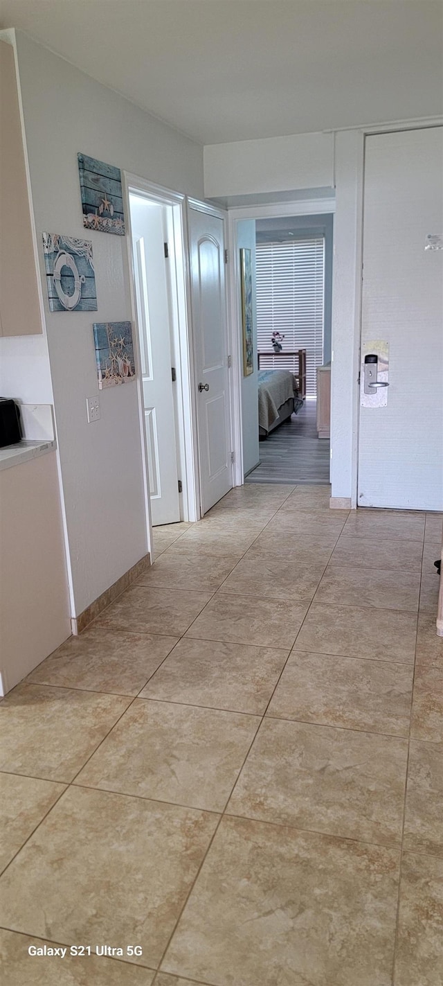 corridor featuring light tile patterned floors