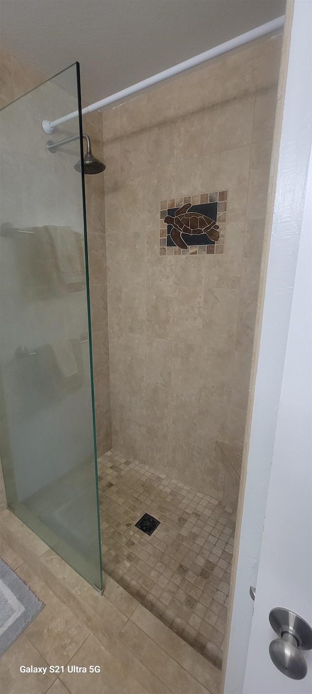 bathroom featuring a tile shower and tile patterned floors