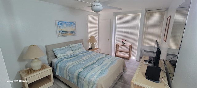 bedroom with light hardwood / wood-style flooring and ceiling fan