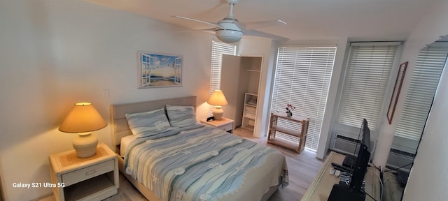 bedroom with ceiling fan and light wood-type flooring