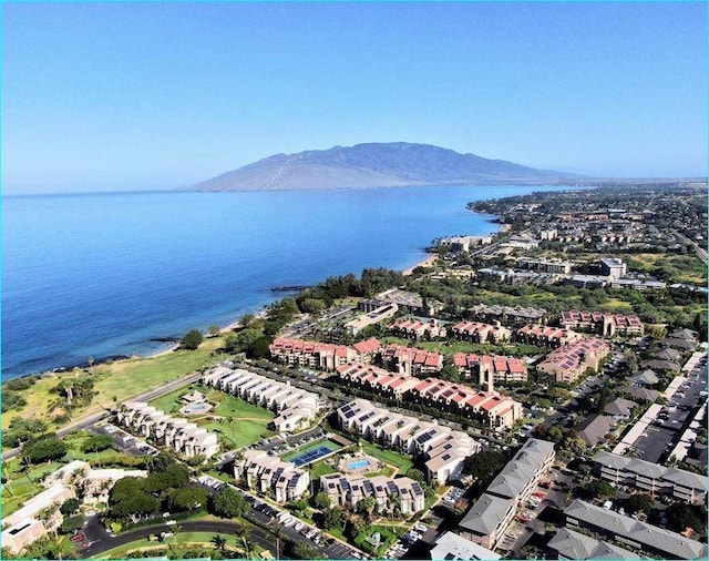 drone / aerial view featuring a water and mountain view