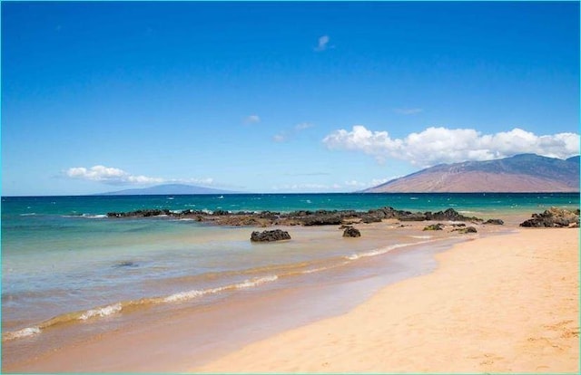 view of water feature with a mountain view and a beach view