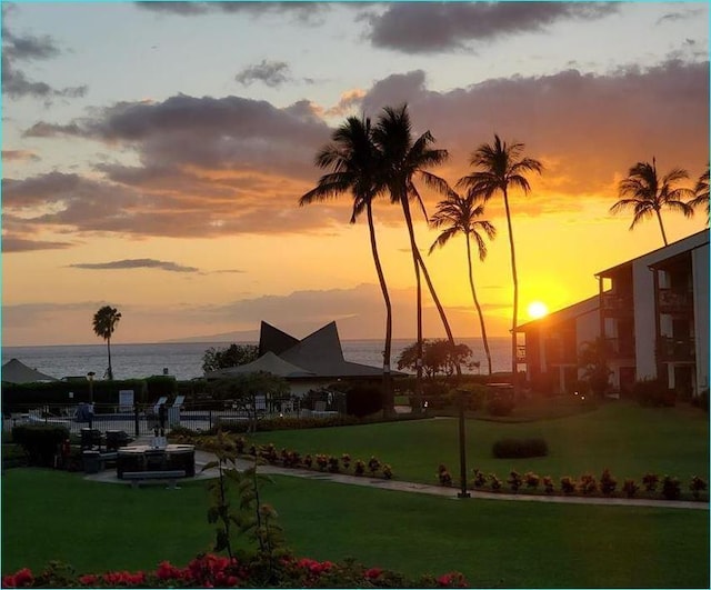 view of community featuring a water view and a lawn