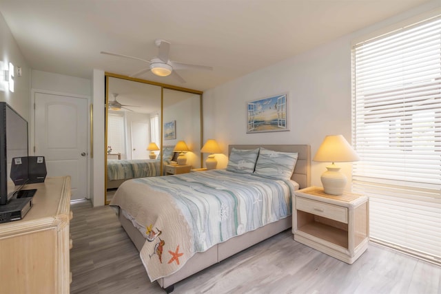 bedroom featuring hardwood / wood-style flooring, a closet, and ceiling fan