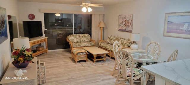 living room with light hardwood / wood-style floors and ceiling fan