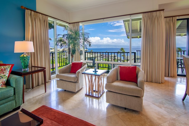 living room with light tile patterned floors and a water view