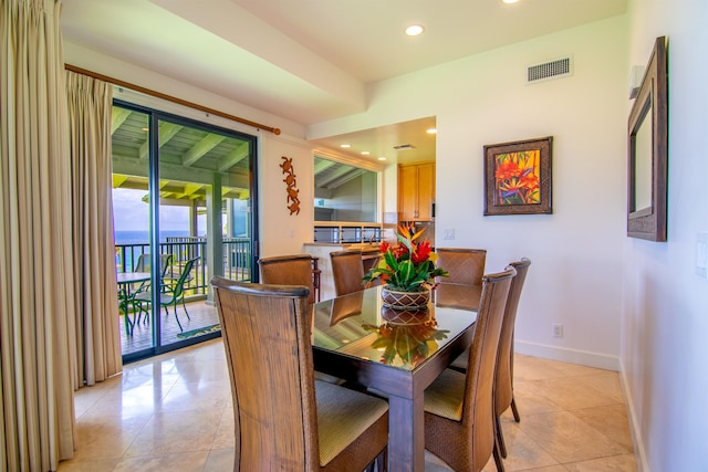 tiled dining space with a wealth of natural light