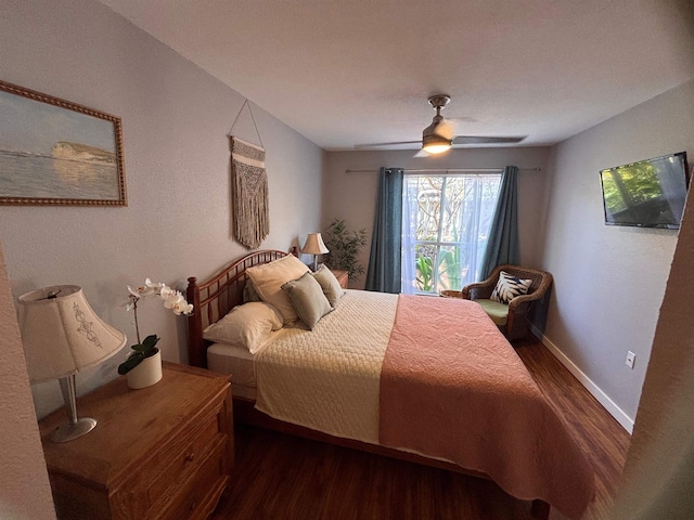 bedroom featuring baseboards, ceiling fan, and wood finished floors