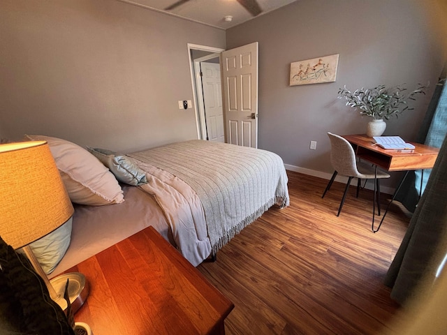 bedroom with baseboards and wood finished floors