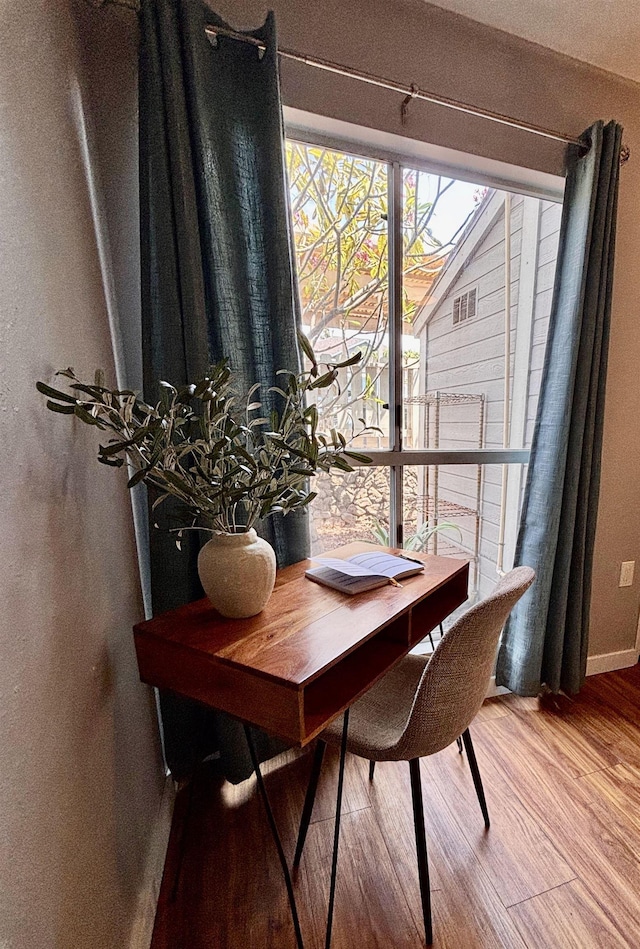 dining space featuring wood finished floors
