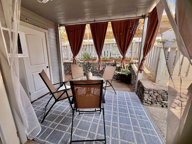 view of patio featuring outdoor dining area and fence