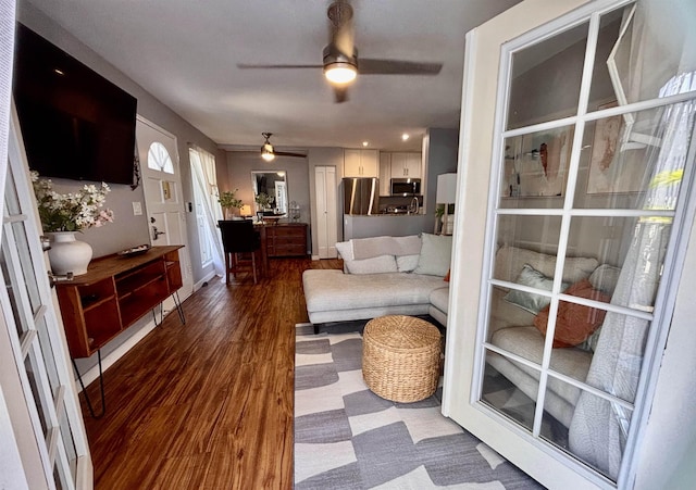 living room with dark wood-style flooring and ceiling fan