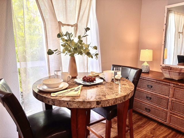 dining space featuring wood finished floors