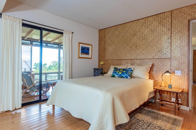 1195 Omaopio Rd Unit A, Kula, HI 96790 - bedroom with access to exterior, wood finished floors, and an accent wall