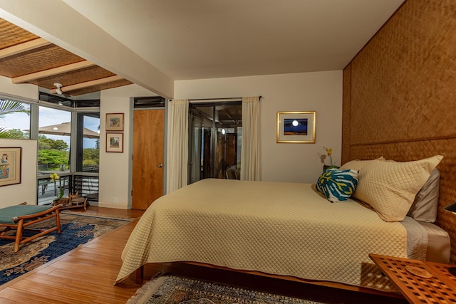 1195 Omaopio Rd Unit A, Kula, HI 96790 - bedroom with access to outside, wood finished floors, and an accent wall