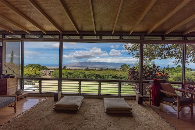 1195 Omaopio Rd Unit A, Kula, HI 96790 - sunroom / solarium featuring wood finished floors, healthy amount of natural light, beamed ceiling, and expansive windows