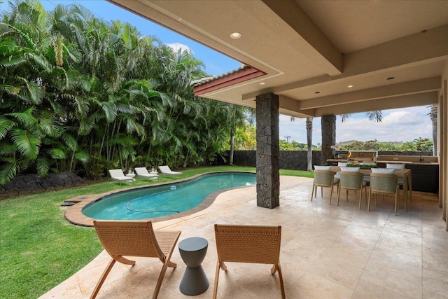 view of pool featuring a yard and a patio