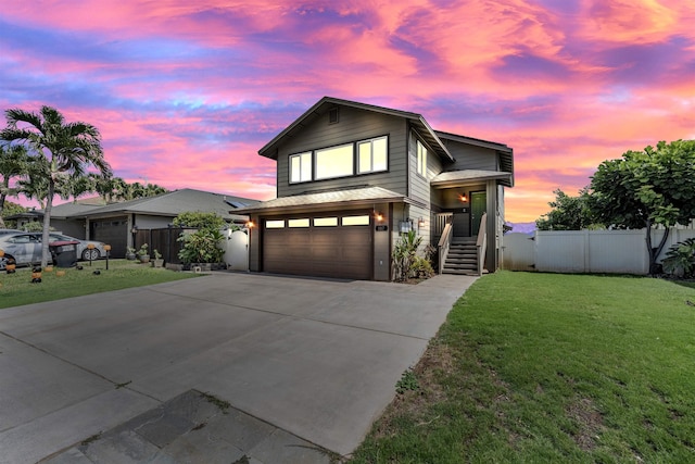 view of front of house with a garage and a lawn