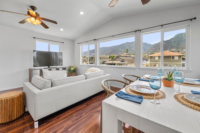 living room featuring vaulted ceiling, dark hardwood / wood-style floors, and ceiling fan