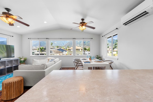 living room featuring an AC wall unit, vaulted ceiling, hardwood / wood-style flooring, and ceiling fan