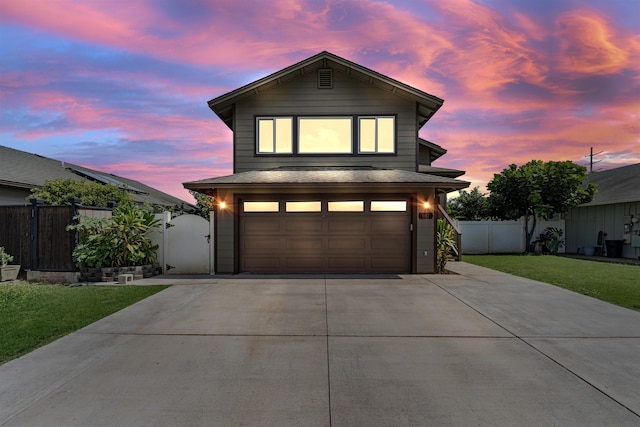 view of front property featuring a garage and a lawn