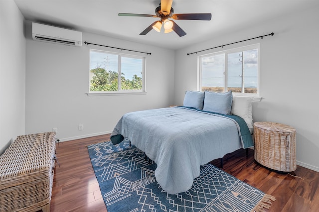 bedroom featuring dark wood-type flooring, ceiling fan, and a wall unit AC