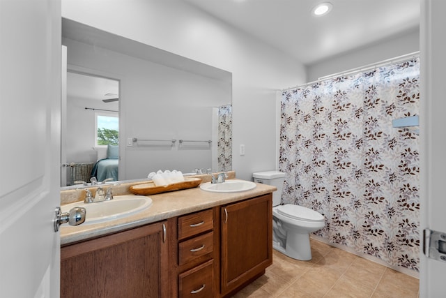 bathroom featuring toilet, vanity, and tile patterned flooring