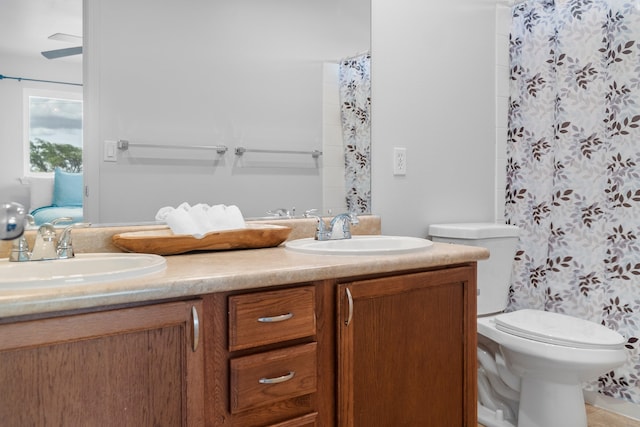 bathroom with toilet, curtained shower, and vanity