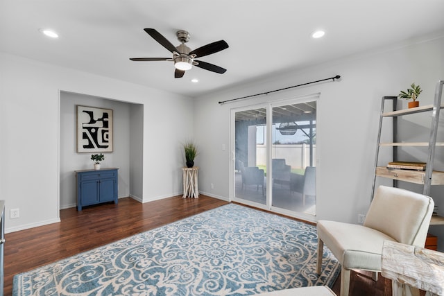 sitting room featuring ceiling fan and dark hardwood / wood-style flooring