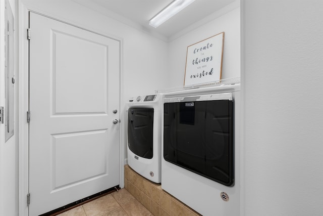 laundry room featuring independent washer and dryer and light tile patterned floors