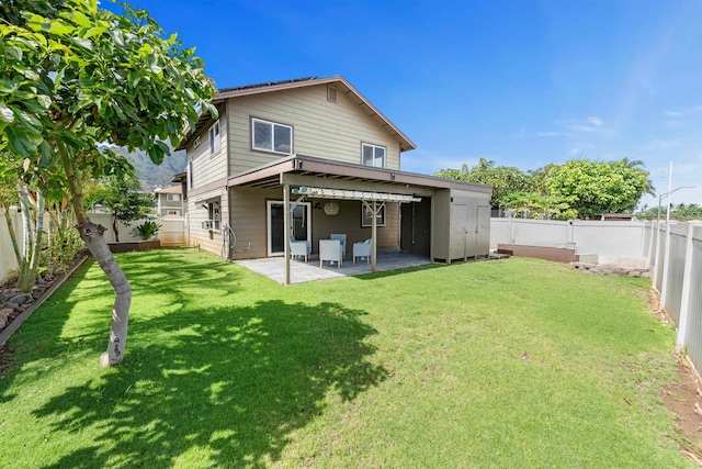 rear view of house with a yard and a patio area