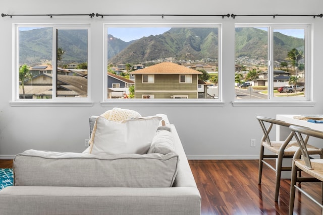 living area with a mountain view and dark hardwood / wood-style flooring