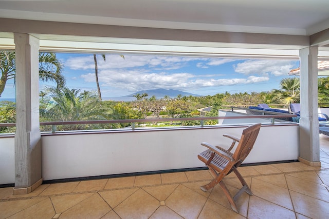 unfurnished sunroom with a mountain view