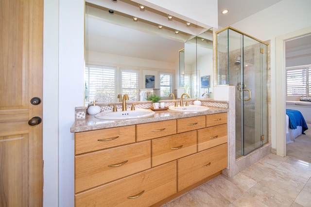 bathroom featuring walk in shower, tile flooring, double sink, plenty of natural light, and vanity with extensive cabinet space