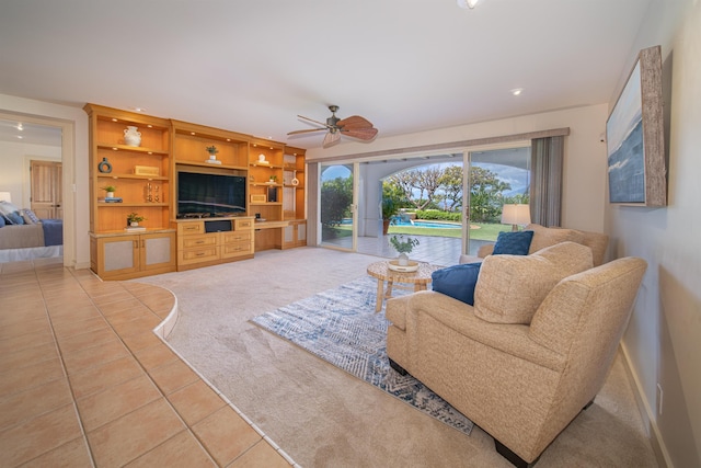 tiled living room featuring ceiling fan, built in shelves, and french doors