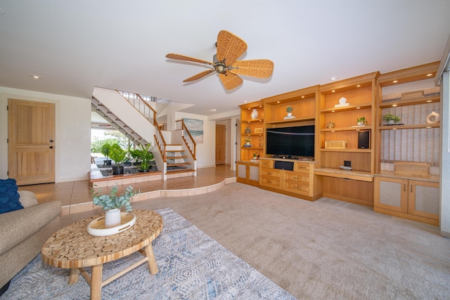 carpeted living room with ceiling fan