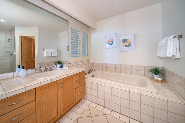 bathroom with tile flooring, shower with separate bathtub, and vanity