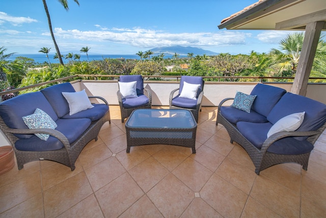 view of patio / terrace with a water and mountain view and outdoor lounge area