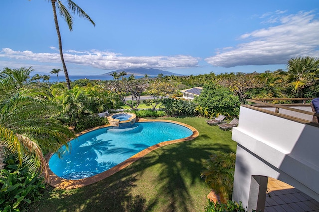 view of pool featuring a lawn and a mountain view