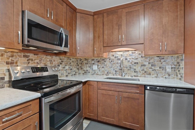 kitchen featuring stainless steel appliances, sink, and backsplash