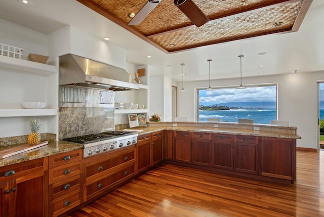 kitchen with stainless steel gas stovetop, kitchen peninsula, decorative backsplash, dark hardwood / wood-style floors, and wall chimney exhaust hood