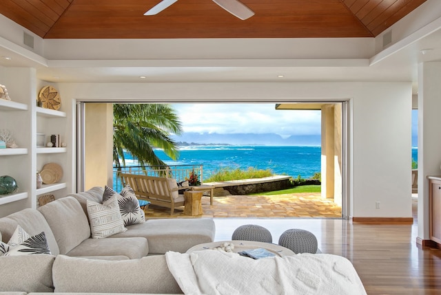 living room featuring ceiling fan, a water view, light wood-type flooring, and wooden ceiling