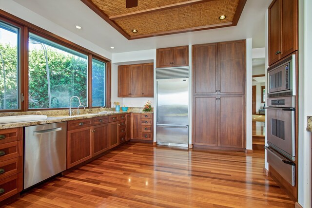 bedroom featuring a water view, lofted ceiling, access to exterior, and wood ceiling