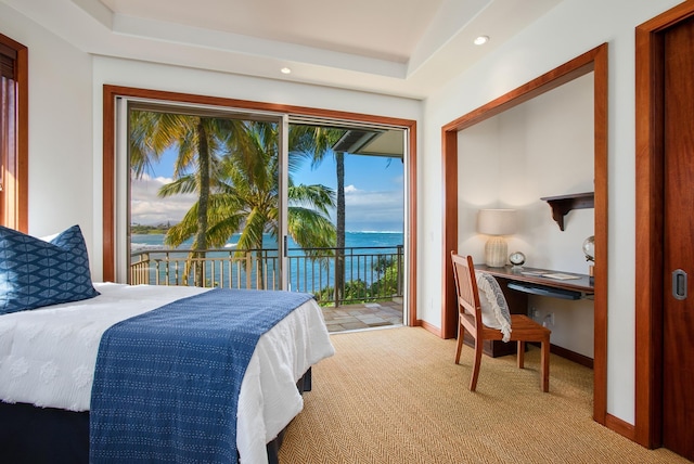 bedroom featuring access to outside, a water view, light carpet, and baseboards