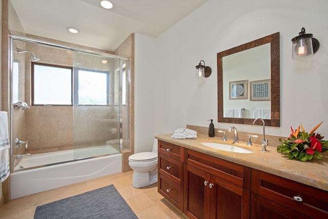 full bathroom featuring toilet, tile patterned flooring, combined bath / shower with glass door, and vanity