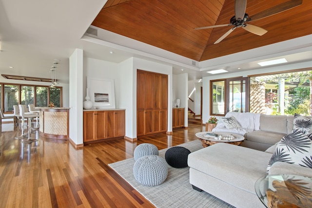 living room with wood-type flooring, ceiling fan, high vaulted ceiling, and wood ceiling