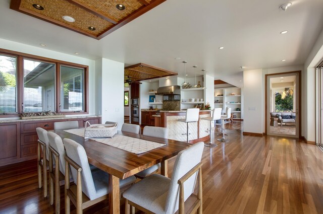 dining area featuring built in features and light hardwood / wood-style flooring