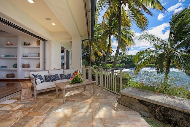 view of patio / terrace with a water view and outdoor lounge area